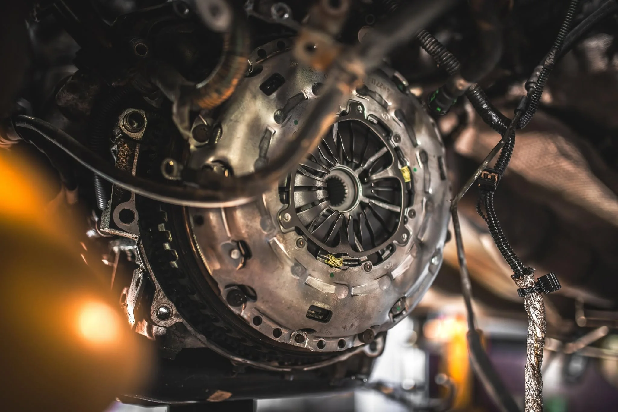 Transmission and clutch housing beneath a vehicle